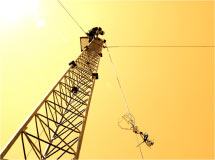 photograph of a scientist atop a sampling tower